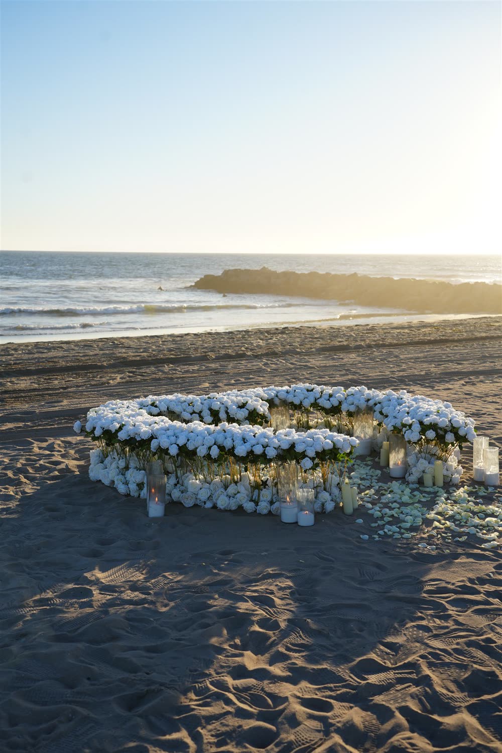 Full white 800 rose heart on the beach at sunset