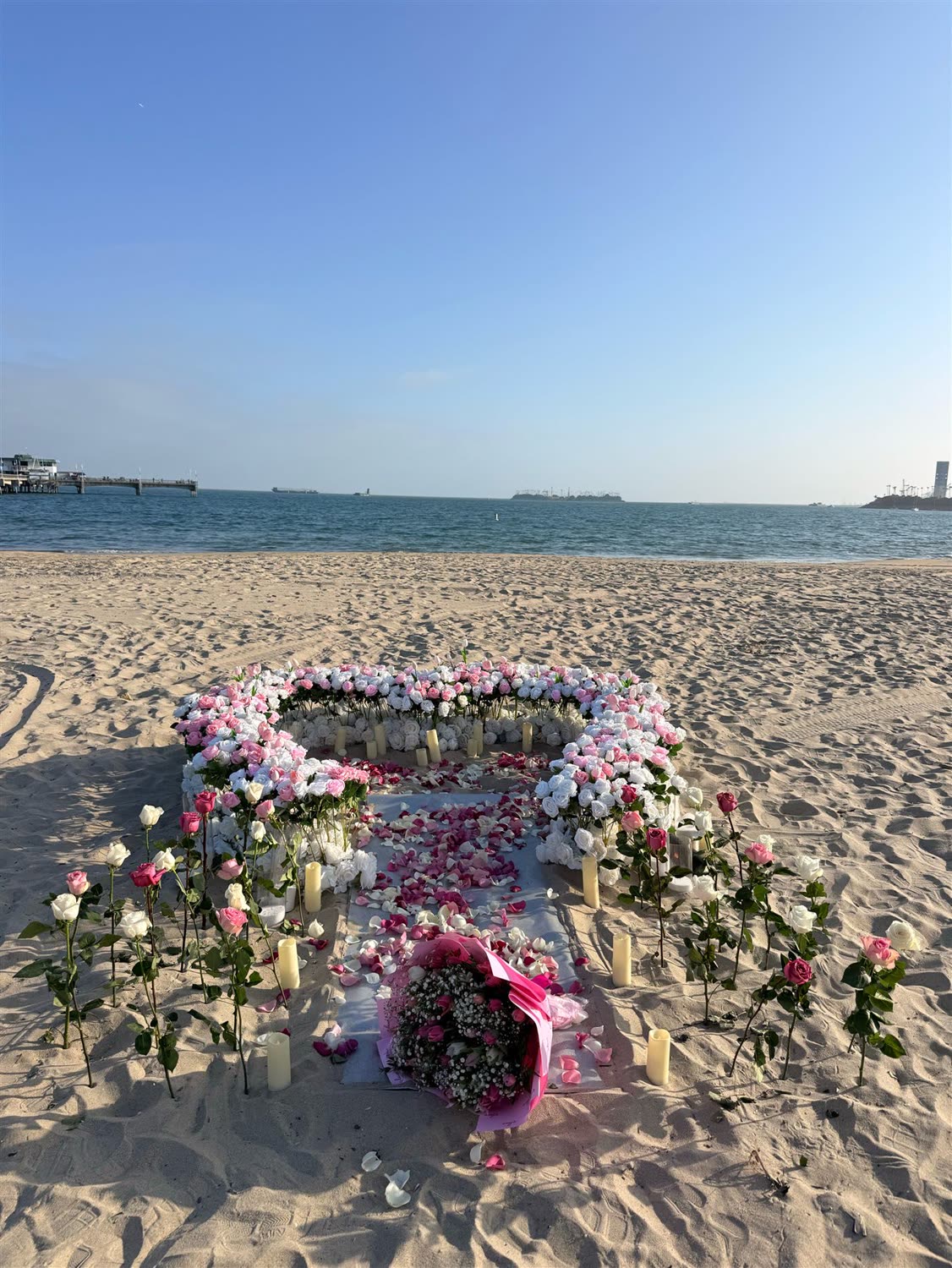 Pink and white rose entrance leading into a large ground heart